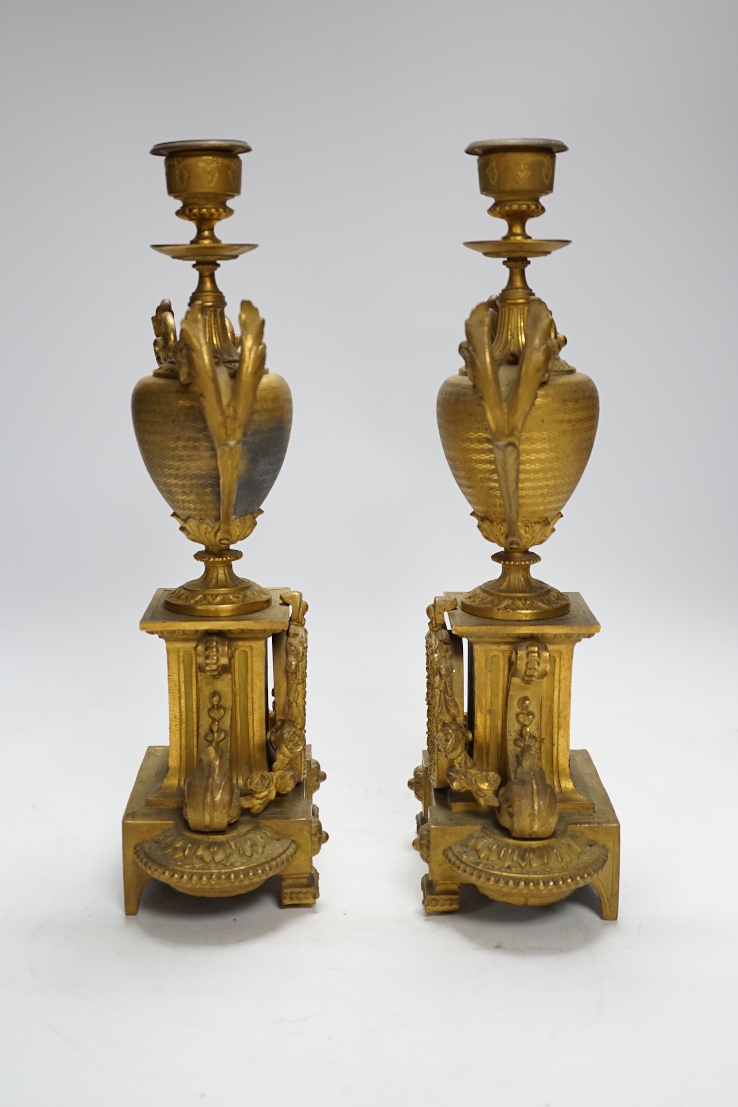 A pair of 19th century French ornamental gilt metal candlesticks, possibly clock garnitures, 32.5cm high